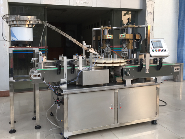 capping machine with 2 capping heads ruuvikorkkilaitteet puoliautomaattinen.jpg